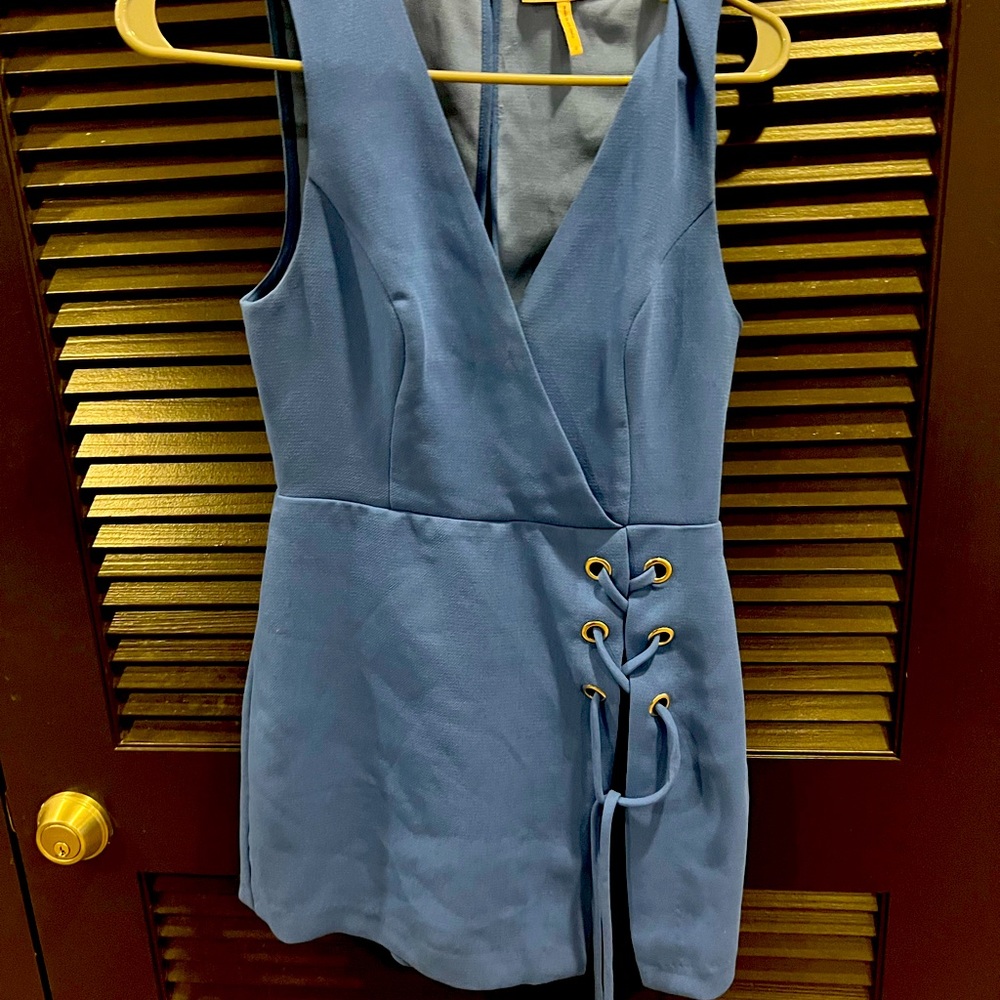 BCBGeneration blue romper, zips in the back with tie design at the bottom.